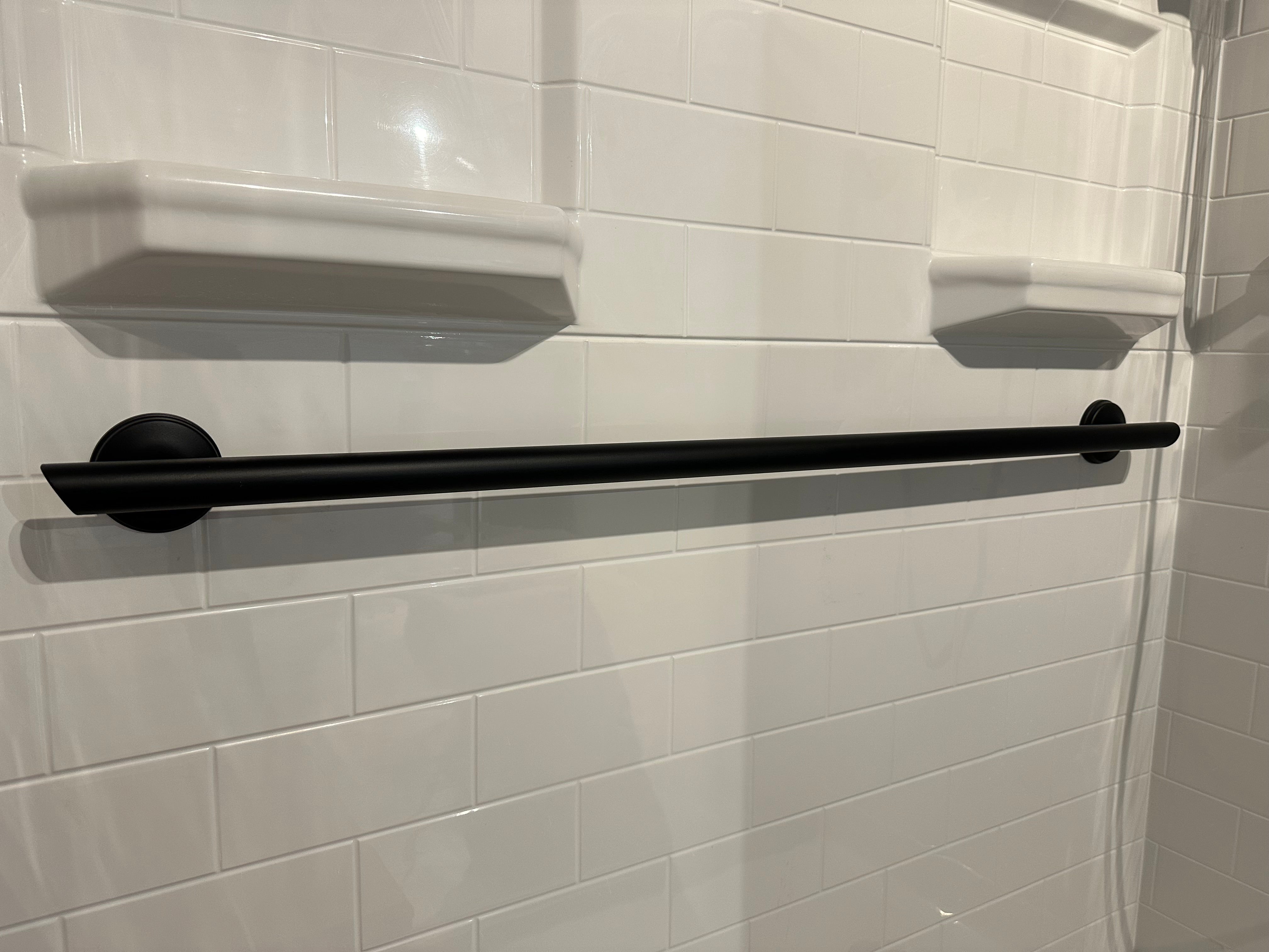 Grabcessories by LiveWell 32, 36, or 42 inch-decorative-grab-bar-angled-ends: "32, 36 or 42-inch straight decorative grab bars with angled ends and multiple rubber grips installed in a bathroom." matte black