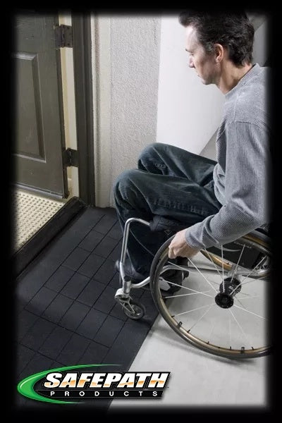 Person in a wheelchair attempting to enter a building with a ramp, featuring the SafePath Products logo. EZEdge™ Wheelchair Ramps