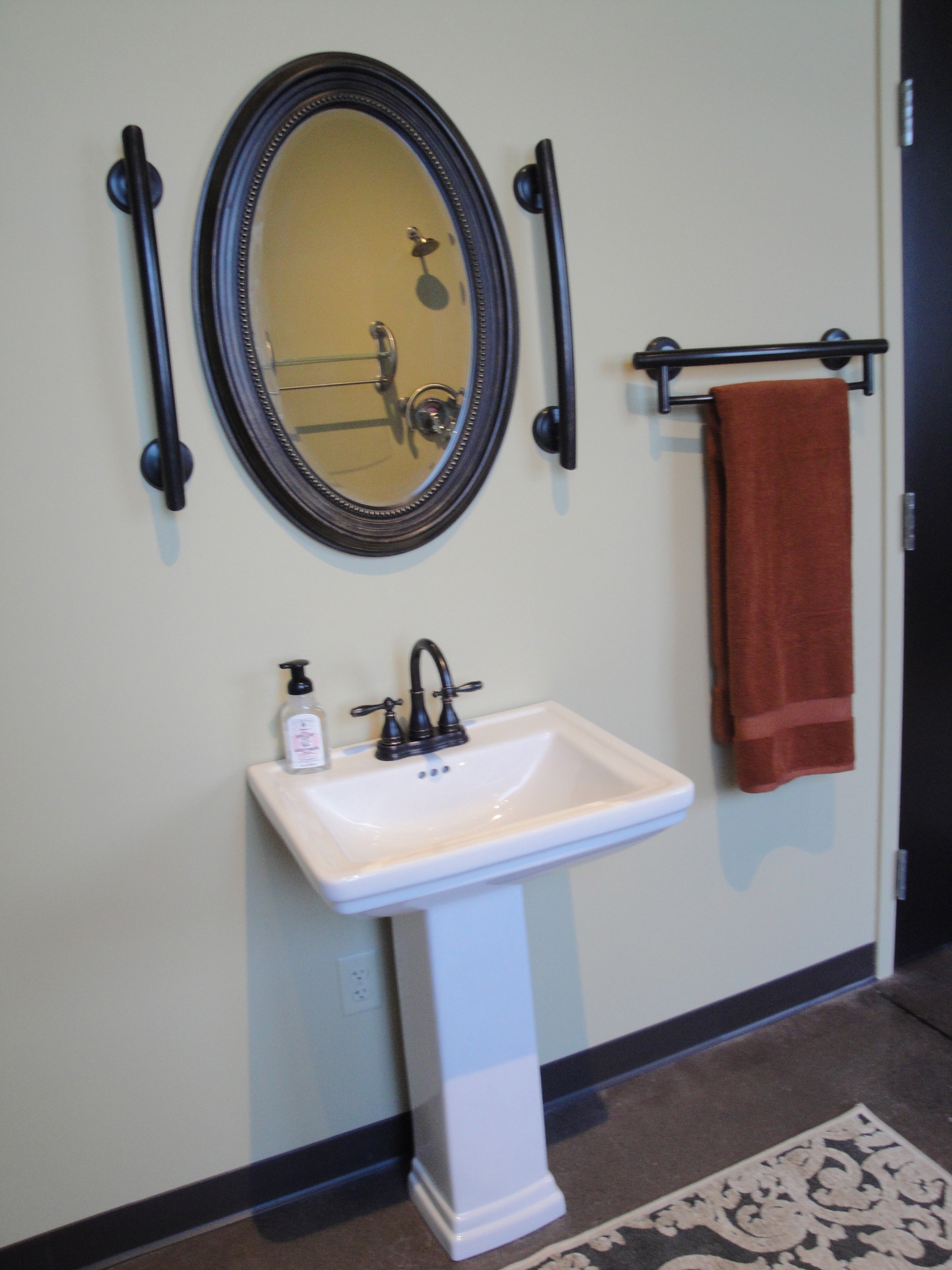 grabcessories-mirror-bars-2-pack: "Grabcessories by LiveWell curved grab bars surrounding mirror 2-pack installed in a modern bathroom."